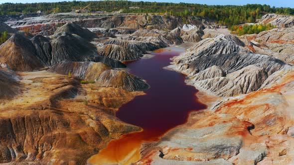 Aerial View of a Landscape Similar To the Planet Mars with Red Hills and Rivers with Red Water alt