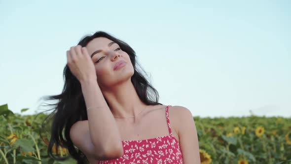 Dreamed Artist Plays with Hair and Start to Paint a Landscape Among Sunflowers alt