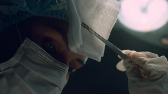 Portrait Surgeon Performing Operation in Dark Hospital Intensive Care Unit Room alt
