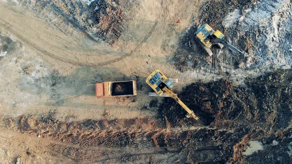 Fast Motion of Working Process at the Extraction Site in a Top View. Heavy Industrial Equipment alt