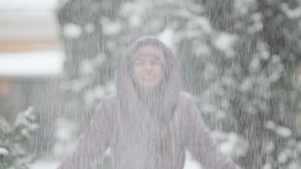 Joyful Slim Young Woman Tossing Snow Outdoors Smiling alt