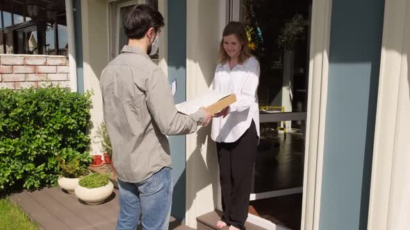 Man in Face Mask and Gloves Delivering Packages alt