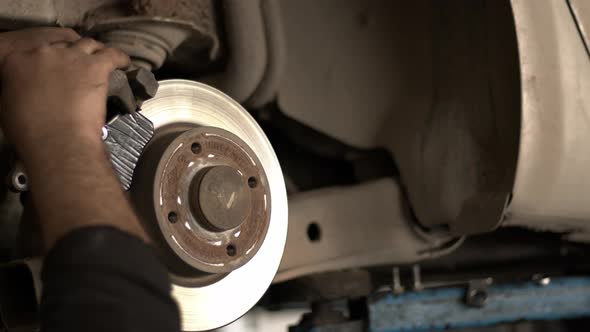 Replacing Old Brake Discs Of A Car In A Repair Shop 3 alt
