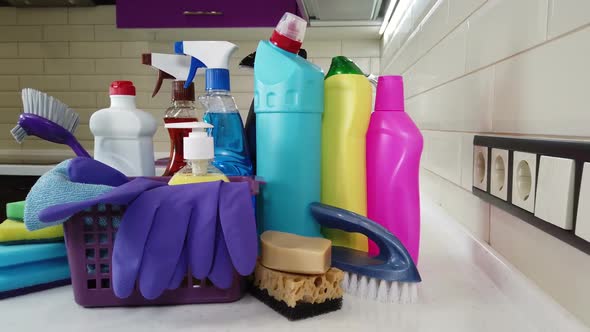 Different Products and Items for Cleaning on the Floor in the Kitchen.