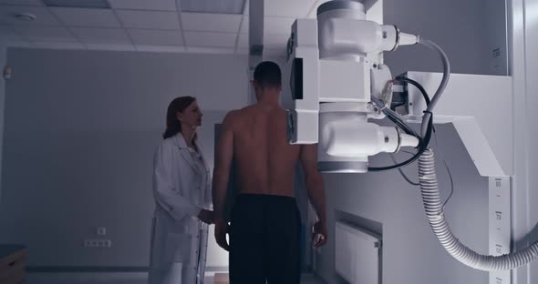 Mature Doctor Starting X Ray Scanning for Male Patient alt