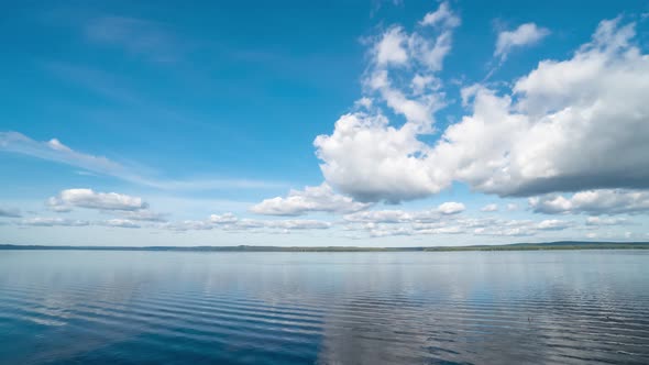 Calm River Landscape with White Clouds in Clear Blue Sky Timelapse alt