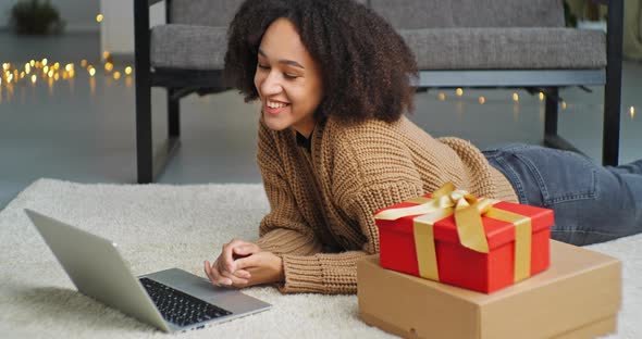 Sociable Ethnic Girl Brunette of African Ethnicity Hispanic Lies on Floor in Cozy Living Room Near alt