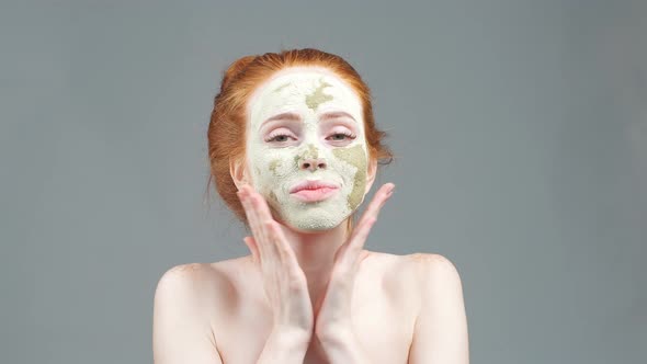 Beauty Portrait Face Mask. Anti-aging Facials. Young Woman Applies a Mask To the Face.