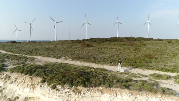 Wind Turbines And Couple Walking Aerial View 