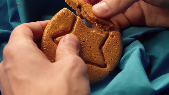 Men's Hands Break Sugar Cookies Candy in the Shape of a Star