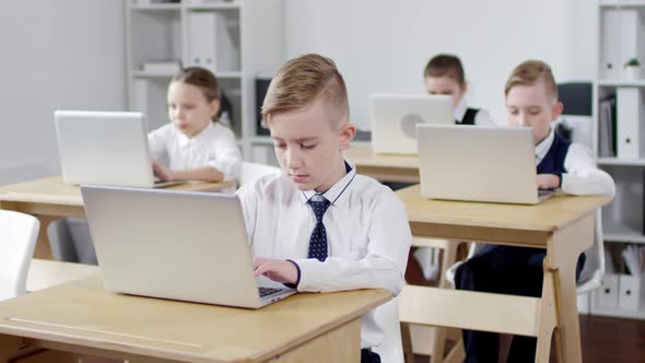 Primary School Pupils Using Laptops in Class alt