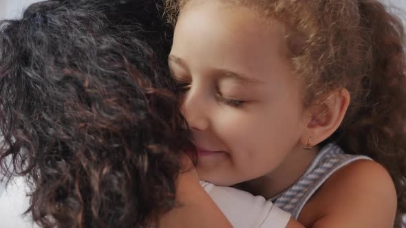 Happy Family Concept. Cute Affectionate Daughter Adopted Little Child Baby Girl Hugs Parent's Mother alt