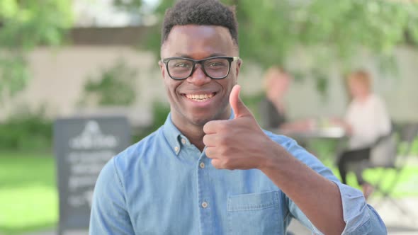 Portrait of African Man Showing Thumbs Up Sign alt