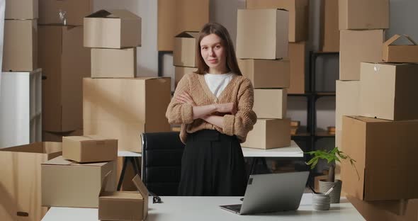 Successful Businesswoman in Room of Apartment Using As Warehouse for Boxes with Goods for Business alt