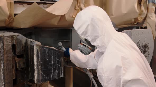 A Painter in a White Coat Covering From Head to Toe Protects the Worker From Getting Paint on the alt