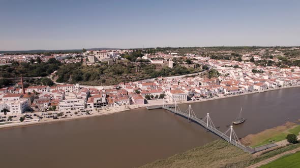 Cityscape of Alcaçer Do Sal city in Portugal with bridge, aerial drone view alt