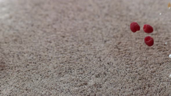 Bowl of cereal and raspberries spilling on carpet in slow motion; shot on Phantom Flex 4K at 1000 fp alt