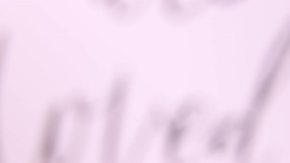 Female hands put a card with words YOU ARE LOVED on a wooden table with ethnic handmade jewelry alt