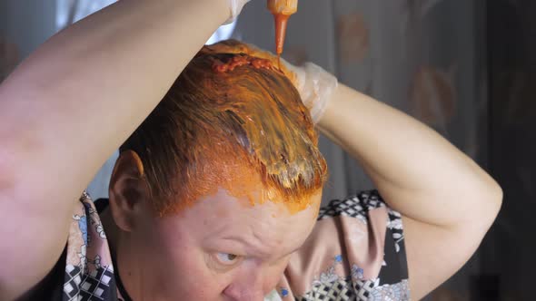 Putting on the Dye Chemicals Onto the Hair of the Lady