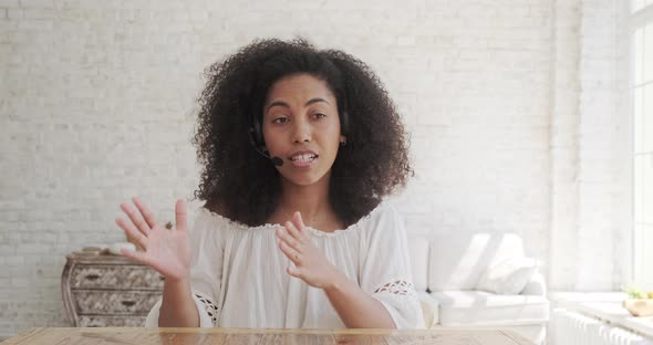 A Black African Businesswoman Speaks to a Web Camera alt
