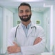 Male Happy Confident Indian Doctor Standing in Clinic Hospital