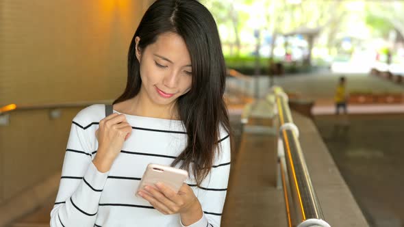 Woman use of mobile phone at outdoor alt