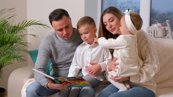 Adorable Family Father Reading a Book to Their Family Sitting in Living Room alt