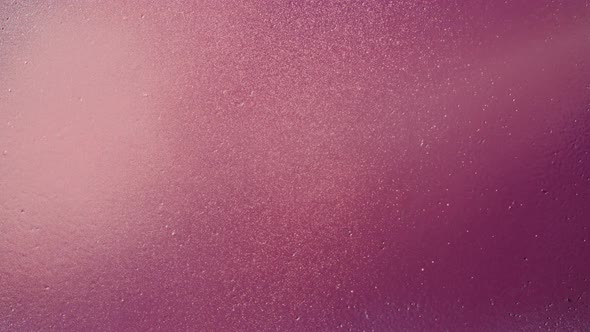 Painting Purple Walls with Pink Paint Using Spray Can Closeup alt