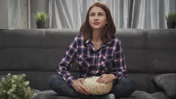 Young Adult Woman Watching Tv at Home