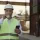 Foreman with Mobile Drinking Coffee While Walking at Work - VideoHive Item for Sale