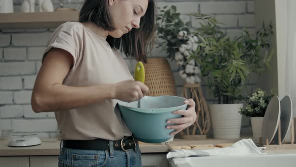 Woman Cooking in the Kitchen By the Window