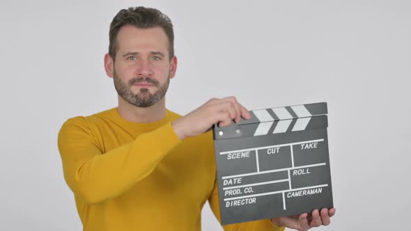 Portrait of Middle Aged Man Using Clapperboard for Shooting alt