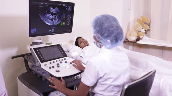 Indian Mother And Ultrasound Operator Viewing Her Fetus 2 alt