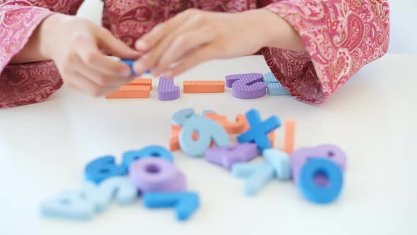 Little Girl Solving Math Task Using Numbers alt
