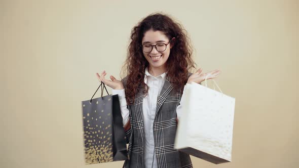 Delighted Young Woman She Holds Many Cardboard Bags in Her Hand Satisfied with the Purchases Made alt