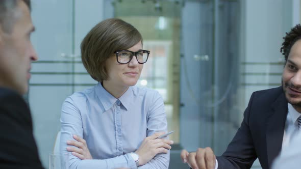 Colleagues Listening to Businessman at Meeting alt