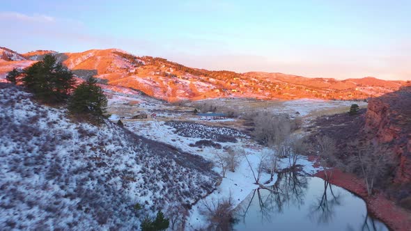 Aerial video of mountains in Boulder, CO. Red Rocks in Winter Colorado Snow Covered. alt