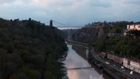 Drone shot along river Avon Hotwell road towards Clifton suspension bridge Bristol at sunset alt