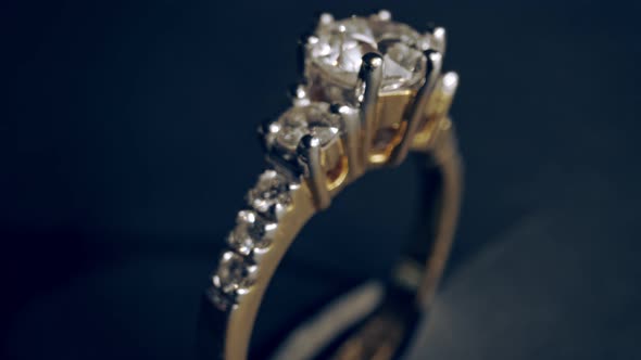 Extreme detailed of diamond ring close up shot while rotating on dark background alt