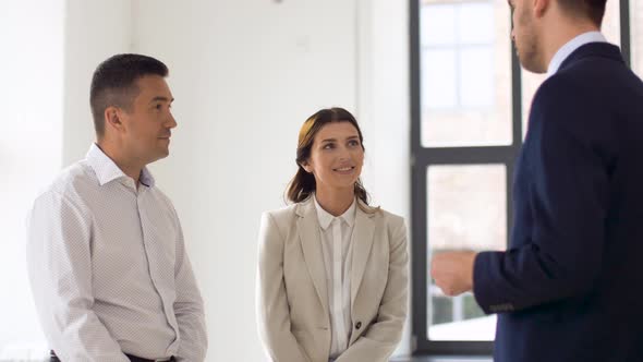 Realtor Giving Key To Customers at New Office alt