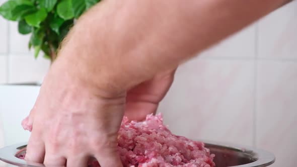 Man Mixes Minced Meat in Bowl His Hands