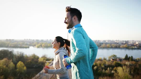 Attractive Man and Beautiful Woman Jogging Together