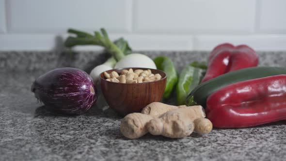 Young Woman Taking Out Vegetables From Grocery Paper Bag In The Kitchen alt
