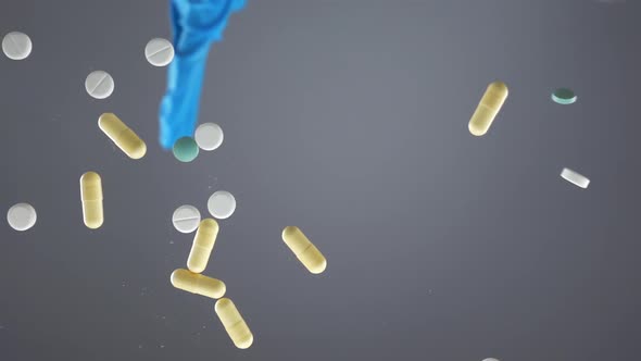 Hand in a Disposable Glove Spills Colorful Pills They Fall in Slow Motion alt