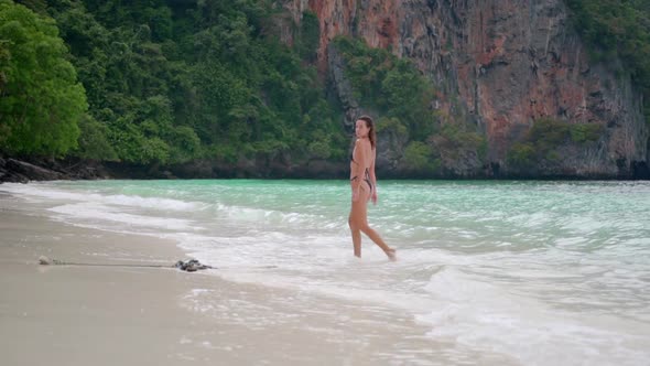 Sexy Young Woman in Swimsuit Walks Out of Water on Tropical Paradise Beach alt
