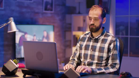 Tired Young Freelancer Working Late Night Hours on Laptop From Home alt