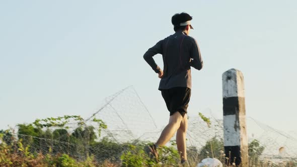 Healthy teenage boys running on the street for exercise. Young male athlete jogging outdoors. alt