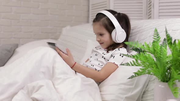 Little Child Baby Girl Listening To the Music with Headphones