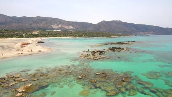 Aerial footage above the rose sand beach at Crete island