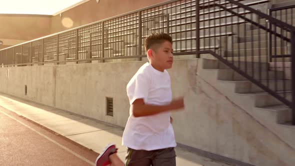 Boy Running On School Track alt